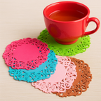 Set of colorful lace coasters with a red mug on a beige surface